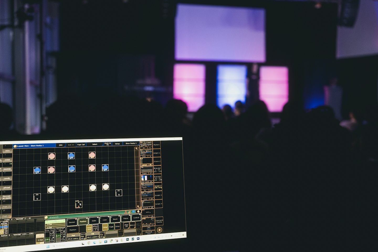 Computer screen showing lighting control software at a live event.