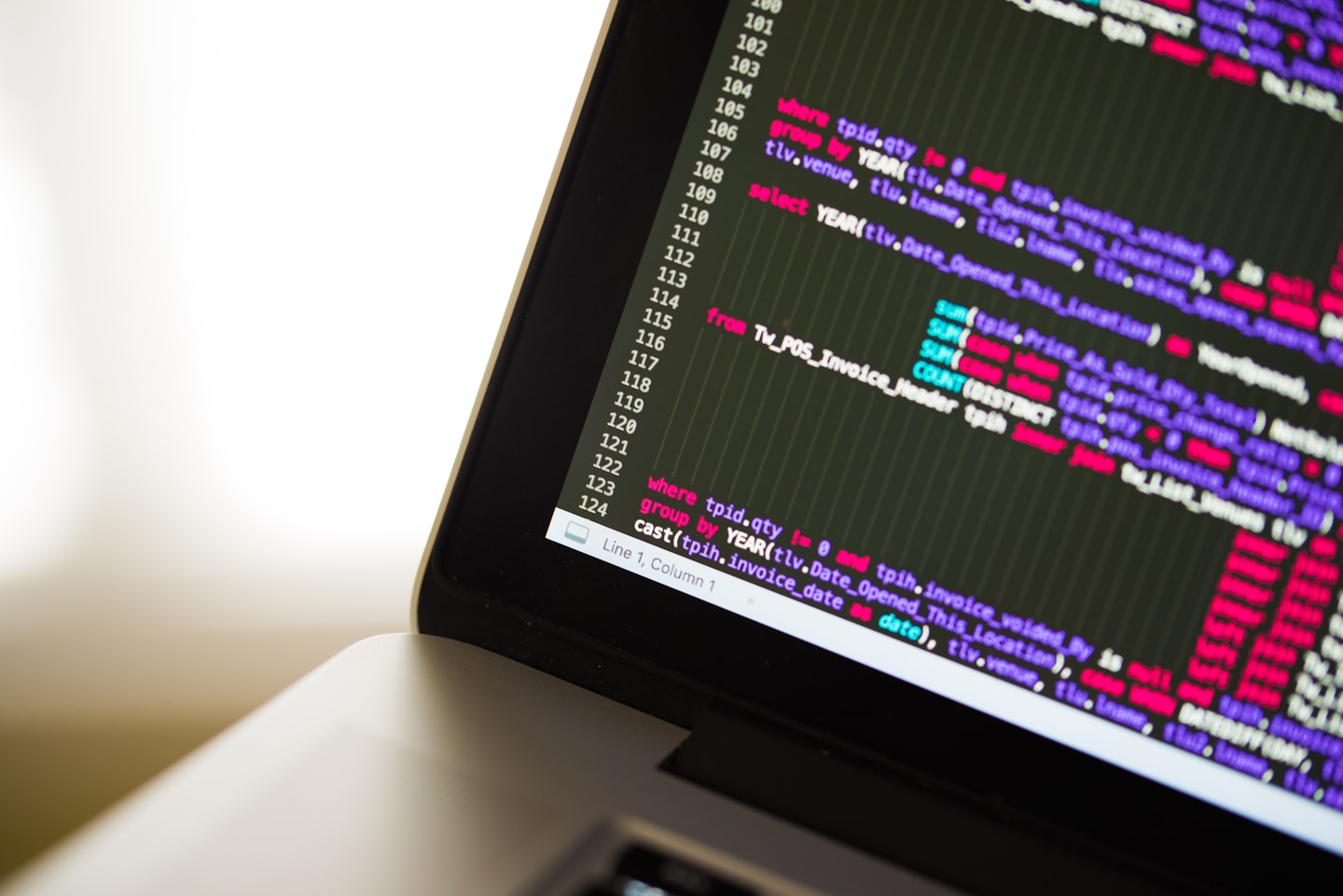 Laptop screen displaying colorful programming code.